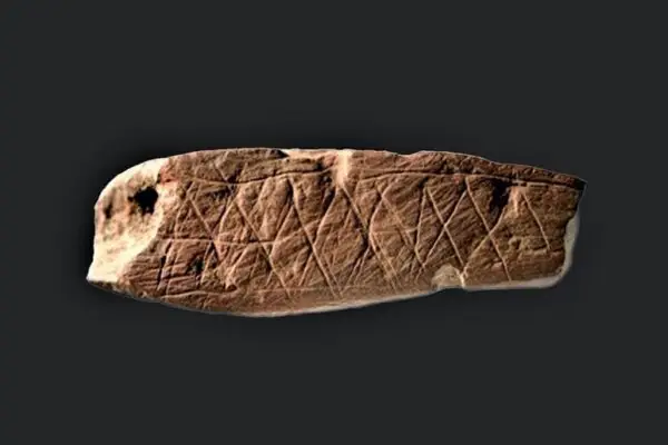 piece of ochre rock with geometric patterns found inblombox cave